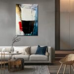 Nowoczesny obraz abstrakcyjny z czarną centralną formą, białym tłem oraz akcentami czerwieni, złota i niebieskiego, utrzymany w minimalistycznym stylu